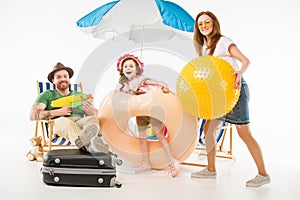 Family with water gun, flotation ring and ball photo