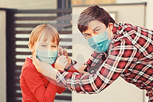 Family wearing face masks outdoors. Prevention coronavirus