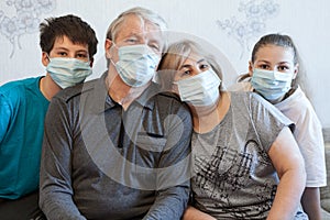 Family wearing protective medical masks for prevent virus, parents with preteen children portrait