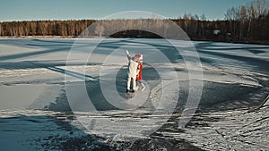 Family weekend spend time together. Happy young couple walking on winter frozen lake. Xmas holidays concept. Christmas
