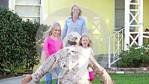 Family Welcoming Husband Home On Army Leave