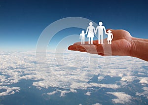 Family welfare concept with hand on aerial sky view background