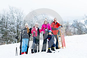 Family in winter vacation doing sport outdoors