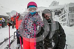 Family on winter vacations taking selfie on mountain slope