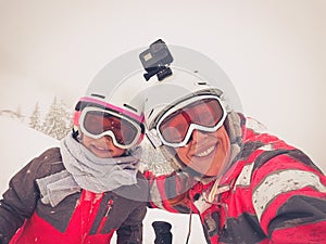 Family on winter vacations taking selfie on mountain slope