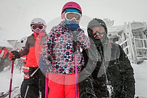 Family on winter vacations taking selfie on mountain slope