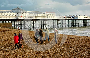 Family winter walk along the beach