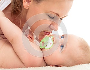 Family. Woman with a newborn child. Portrait of beautiful smiling young mother with a baby