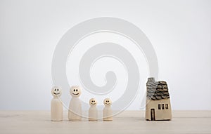 Family wooden dolls and home model, family and home concept