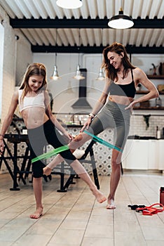 Family working out at home with elastic band.
