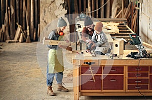 Family working together in woodwork workshop photo