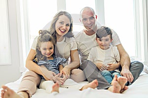 Family with young children to bed in the bedroom