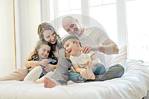 Family with young children to bed in the bedroom