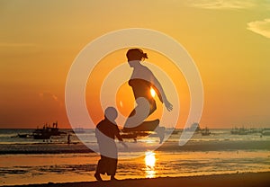 Famiy jumping at sunset