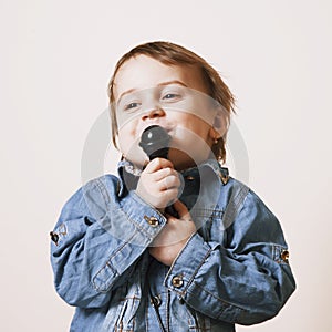 The famous actress. Humorous photo baby girl singing with a microphone (creativity, music, success concept)