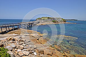 Famous Bare Island and its wooden footbridge in sunset light, Sydney Australia.