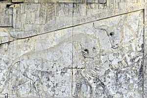 Famous bas relief carving of a lion hunting a bull in Persepolis World Heritage Site