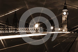 Famous and Beautiful night view to Big Ben and Houses of Parliament from Westminster Bridge through nigh lamp rays, London, UK