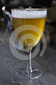 Famous Belgian beer served outside in small old cafe in special Belgian beer glass