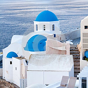 Blue Domed Church in Oia town and sea view on Santorini island, Cyclades, Greece