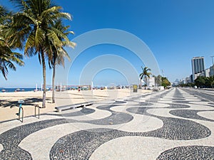 Famous Boardwalk on Copacabana Beach and coconut trees with blue sky in Rio de Janeiro Brazil