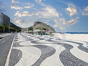 Famous Boardwalk on Copacabana Beach and coconut trees with blue sky in Rio de Janeiro Brazil