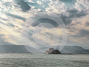 The famous Bourtzi, a Venetian water fortress at the entrance of the harbour in Nafplio seaside city in Argolis, Peloponnese,