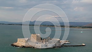 The famous Bourtzi, a Venetian water fortress at the entrance of the harbour in Nafplio seaside city in Argolis, Peloponnese,