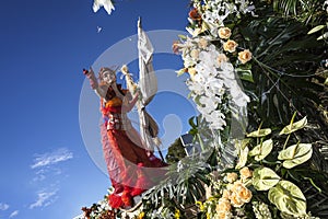 Famous Carnival of Nice, Flowers`battle. A woman entertainer launches white flower