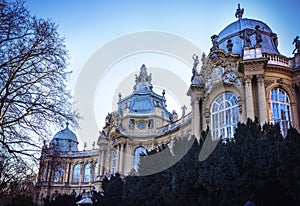 Statue of a lion at entrance and stone gate at entrance to to Vajdahunyad Castle in City Park of Budapest, Hungary.