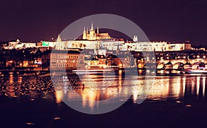 Famous castle and Charles bridge mirroring in Vltava river, Prague, Czech republic. Night scene. Travel destination. Architectural