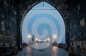 The famous Charles bridge in Prague, Czech Republic, on a foggy winter morning