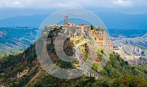 The famous Civita di Bagnoregio hit by the sun on a stormy day. Province of Viterbo, Lazio, Italy.