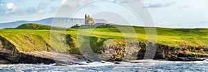 Famous Classiebawn Castle in picturesque landscape of Mullaghmore Head. Spectacular sunset view with waves rolling ashore.