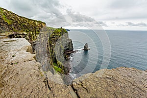 The famous Cliffs of Moher and the Branaunmore sea stack seen from a plateau