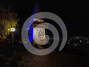 The famous Clock Tower (Grazer Uhrturm) on Shlossberg hill, Graz, Styria region, Austria, by night