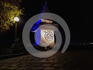 The famous Clock Tower (Grazer Uhrturm) on Shlossberg hill, Graz, Styria region, Austria, by night