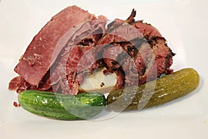 Famous Corned Beef and Pastrami on rye sandwich served with pickles