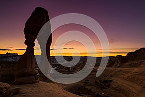 Famous delicate arch in Utah at sunset with colors in the sky