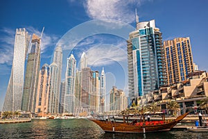 Dubai Marina with boats against skyscrapers in Dubai, United Arab Emirates