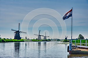 famous dutch windmills at riverside with Dutch flag