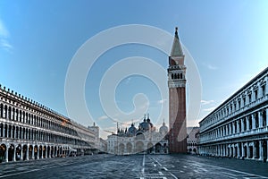 Famous empty San Marco square with Basilica of Saint Mark and Bell Tower at sunrise,Venice,Italy.Early morning at popular tourist