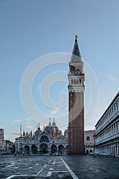 Famous empty San Marco square with Basilica of Saint Mark and Bell Tower at sunrise,Venice,Italy.Early morning at popular tourist