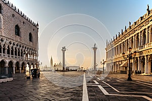 Famous empty San Marco square with Doges Palace at sunrise,Venice,Italy.Early morning in popular tourist destination.World famous