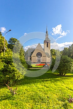 Famous Evangelical Lutheran Church of Transfiguration of Lord in Zelenogorsk. Green alley with grass and Square of