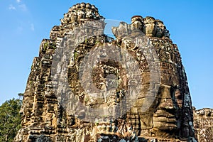 Famous faces of Bayon, the most notable temple at Angkor Thom, Cambodia photo