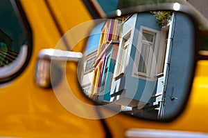 Famous Fener or Balat traditional houses reflected on a car's mirror in Istanbul