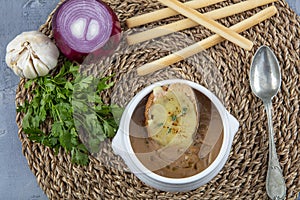 Famous French dish, French onion soup. Caramelised onions cooked in stock with wine and herbs, topped with toasted baguette and