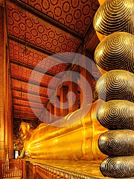 Famous golden reclining buddha statue at wat pho in Bangkok Thailand
