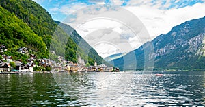 Famous Hallstatt city panorama with typical church near the Hallstatter see. Dramatic clouds on the sky. Famous tourist
